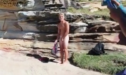 Cute blond boy taking a shower naked in front of his friends