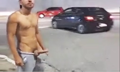 Muscular boy with hard cock on public street