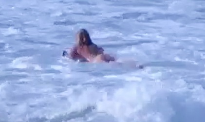 Blond surfer boy surfing naked